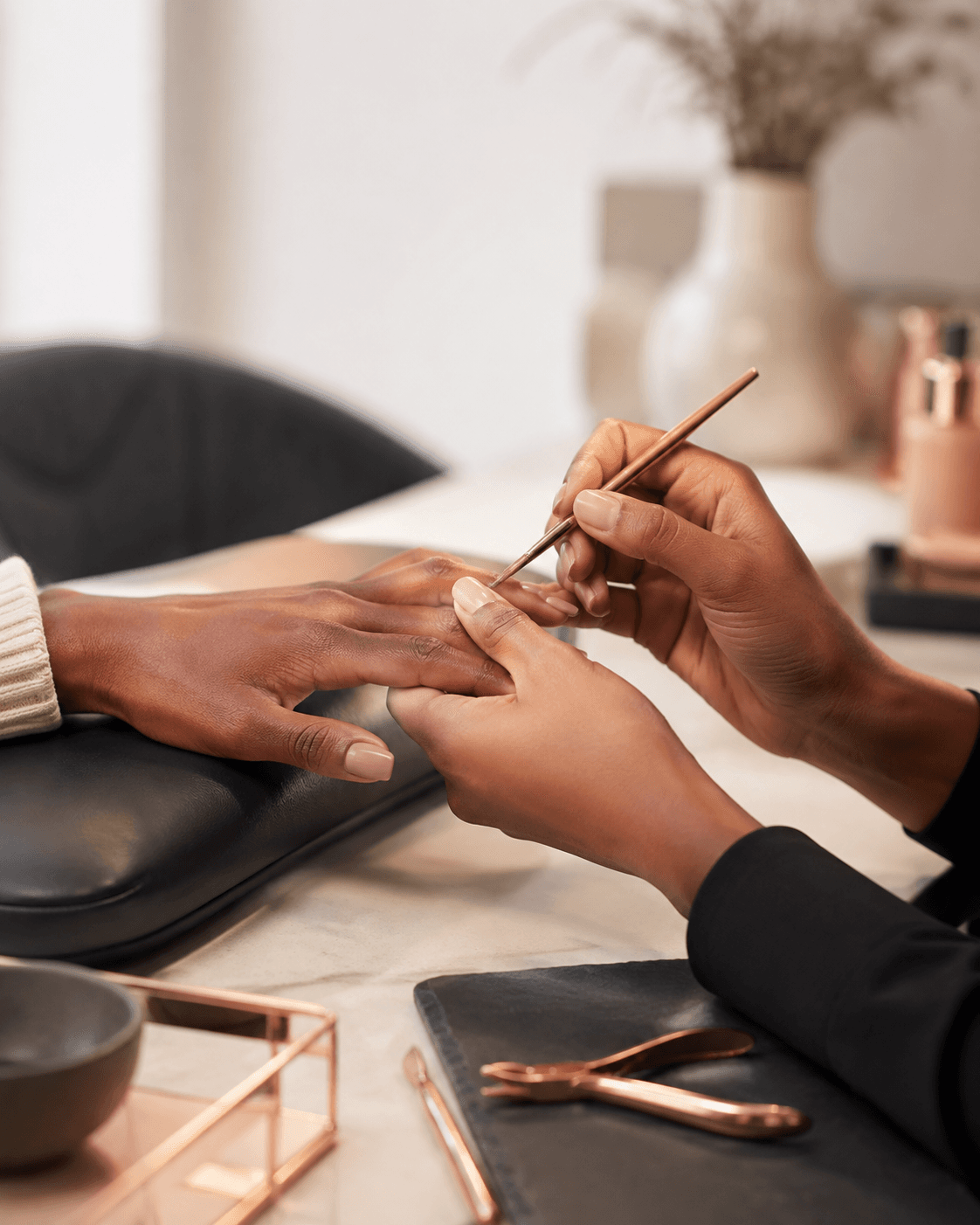 Nail artist performing a manicure at Atelier Belle